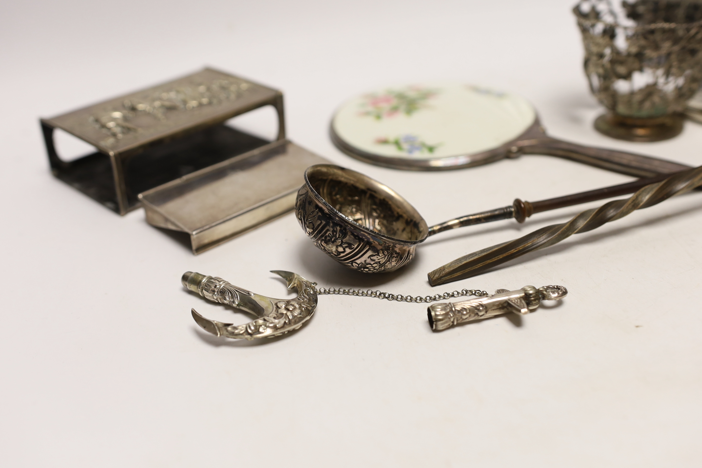 A group of assorted silver and white metal items including a George V trinket box, cigarette case, sterling stamp box, Dutch matchbox holder, George V sugar basket by William Comyns (no liner), two toddy ladles and two o